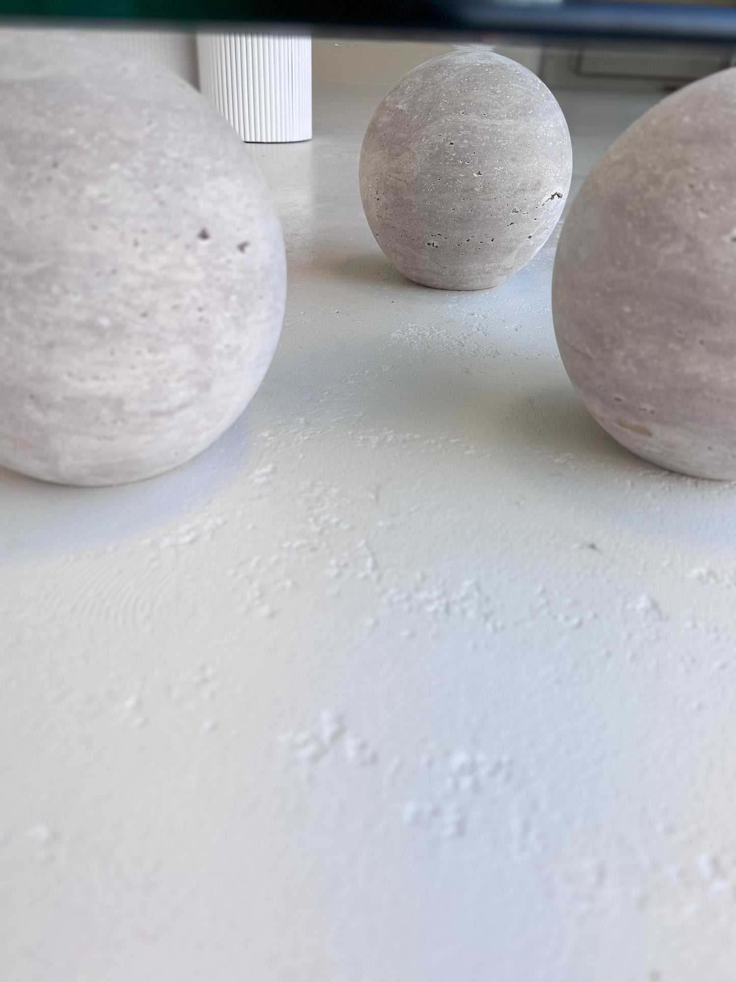 World Globe Organic-shaped Coffee Table with glass top and sculptural travertine base in a modern interior