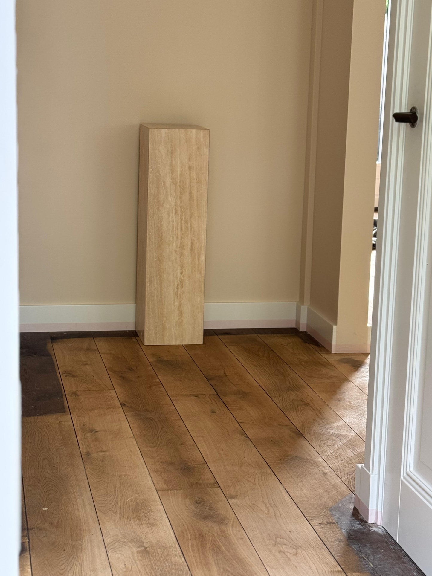 Rectangular travertine pedestal with honed stone texture
