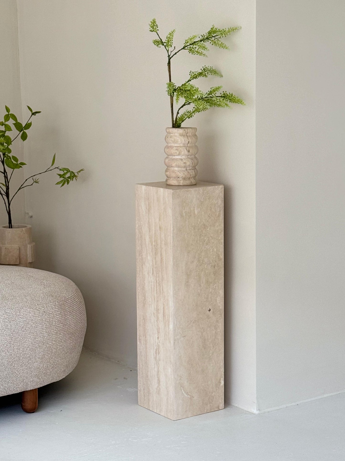 Lucy Travertine Pillar styled with vase in modern interior
