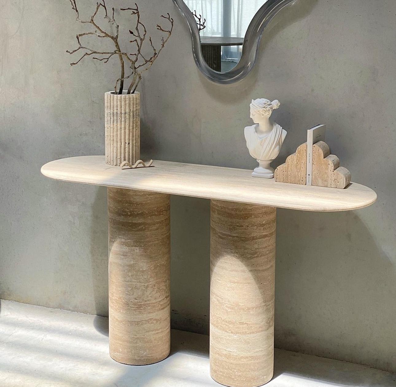 Dorica Travertine Console Table with oval top and three cylindrical legs in honed Veincut natural stone