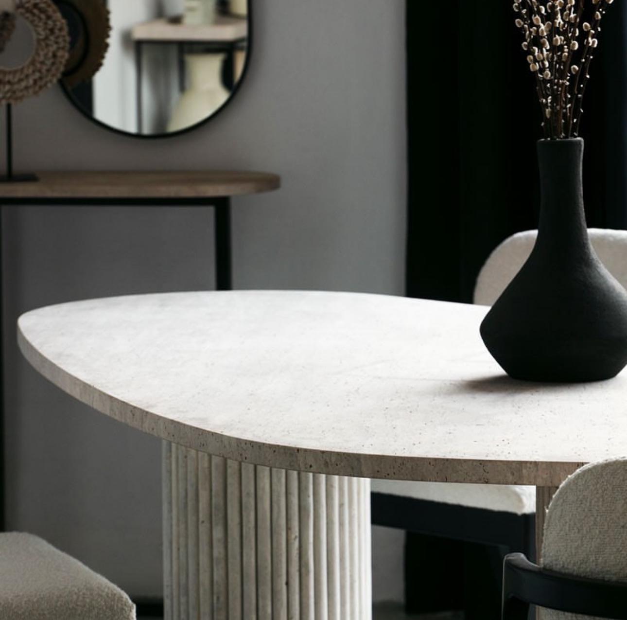 Travertine Bova | Triangular Dining Table styled in a minimalist dining space