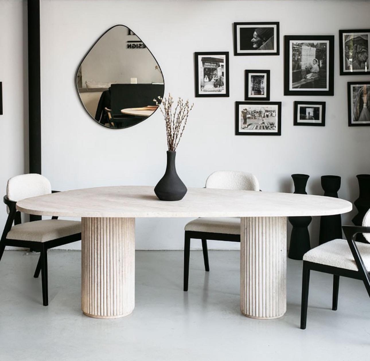 Travertine Bova | Triangular Dining Table styled in a minimalist dining space
