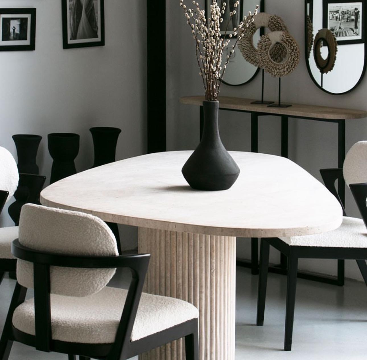 Travertine Bova | Triangular Dining Table styled in a minimalist dining space