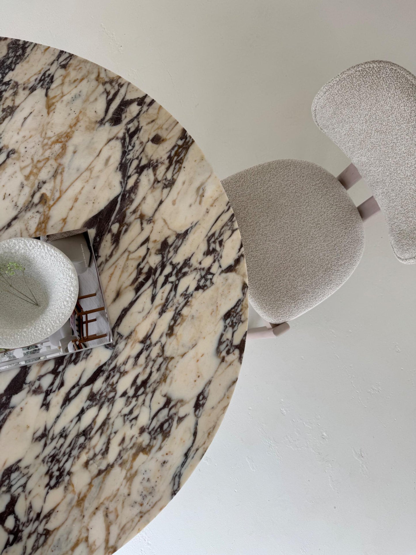 The Conical Violet | Marble Round Dining Table displayed in a minimalist interior