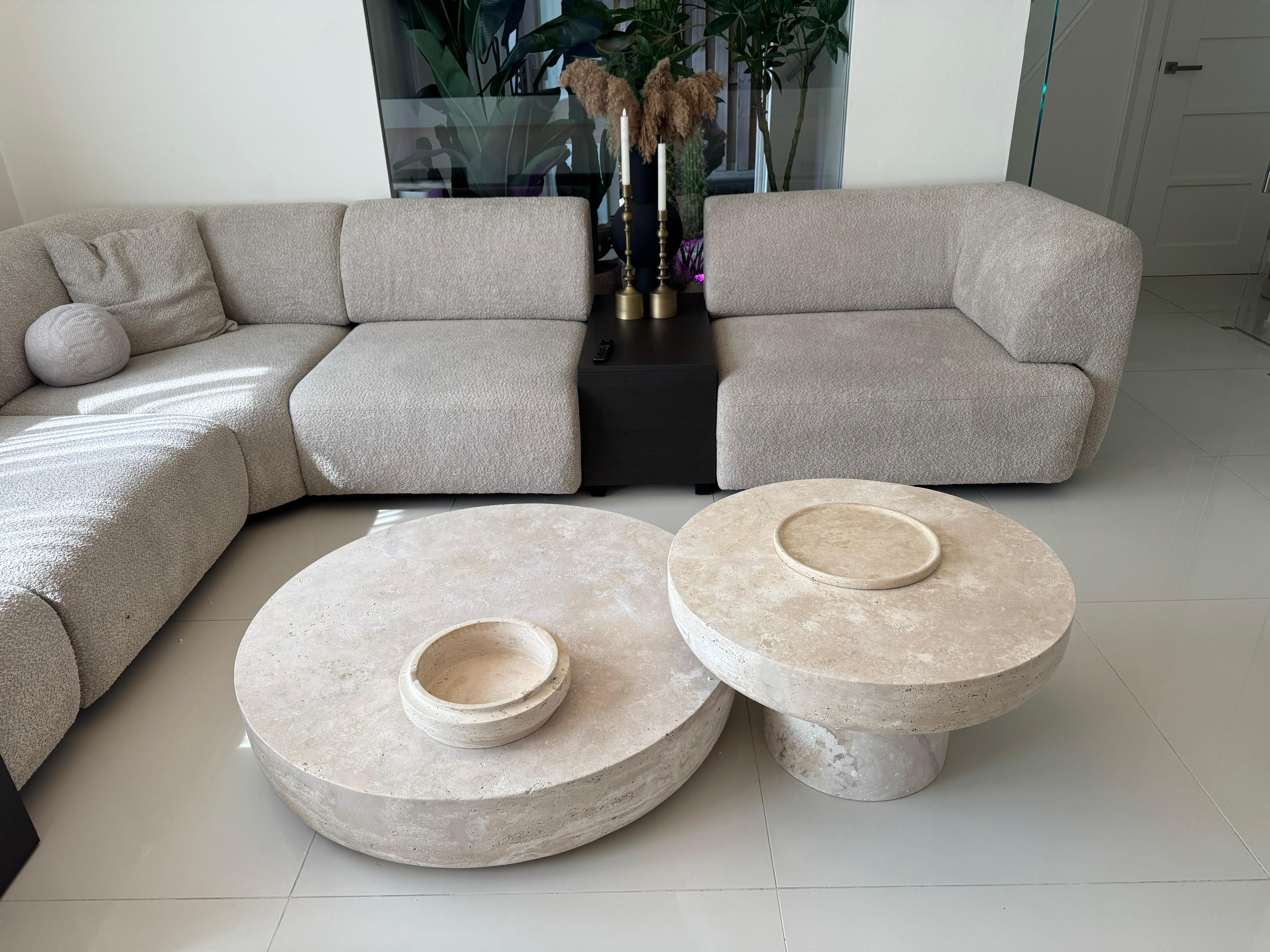Round handmade travertine crosscut coffee table in minimalist luxury design, made from natural stone
