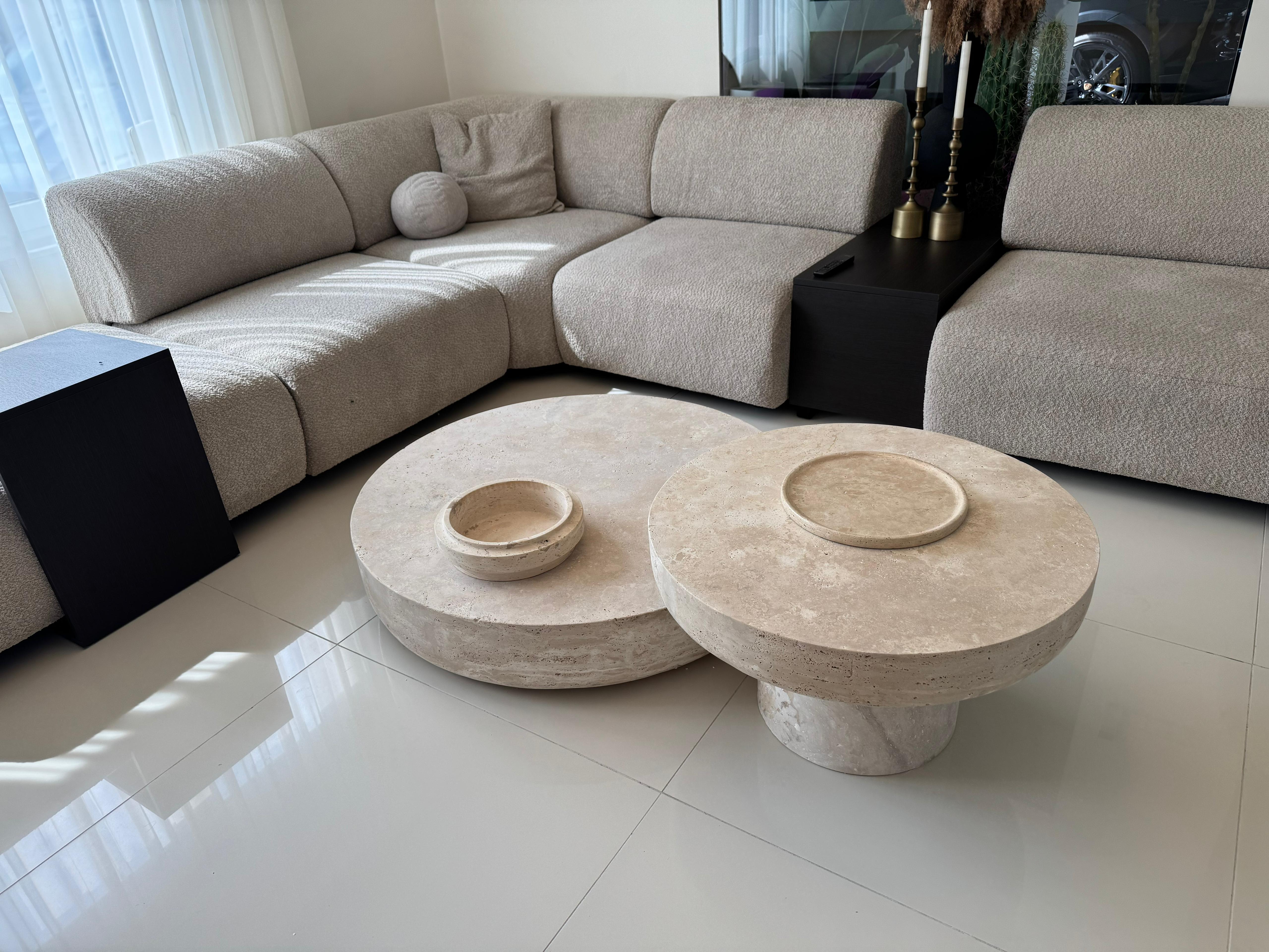 Round handmade travertine crosscut coffee table in minimalist luxury design, made from natural stone