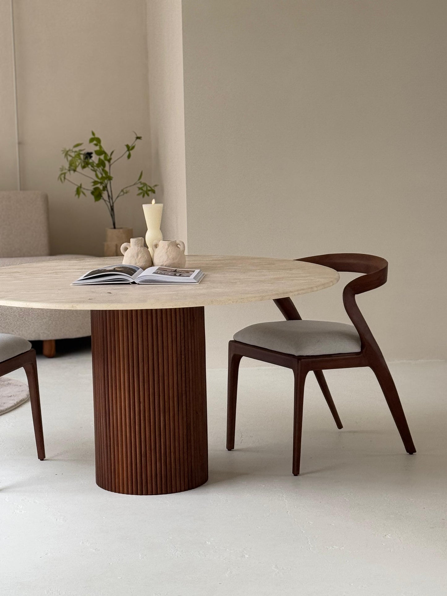 Lavanda dining table featuring veincut travertine top and handcrafted pedestal