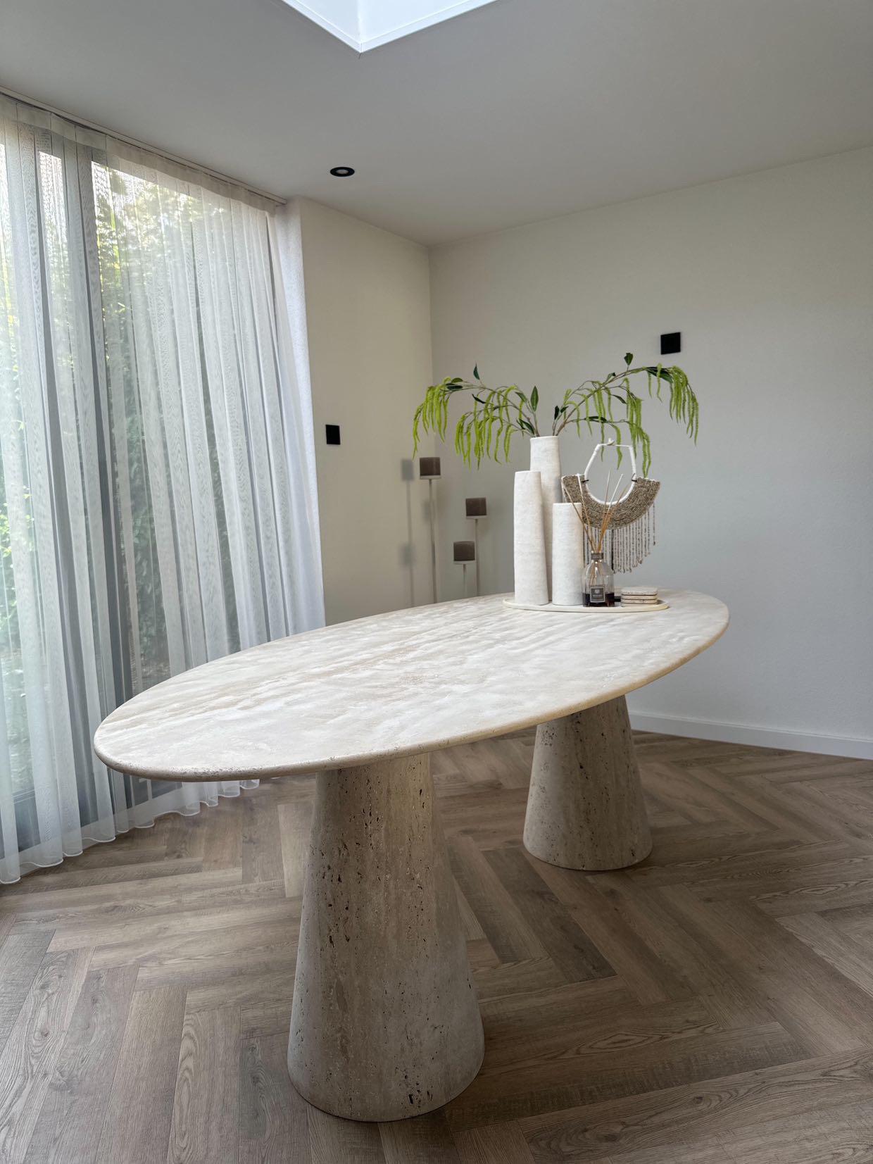 Front view of Travertine Oval Dining Table | Cone Leg with natural stone veining