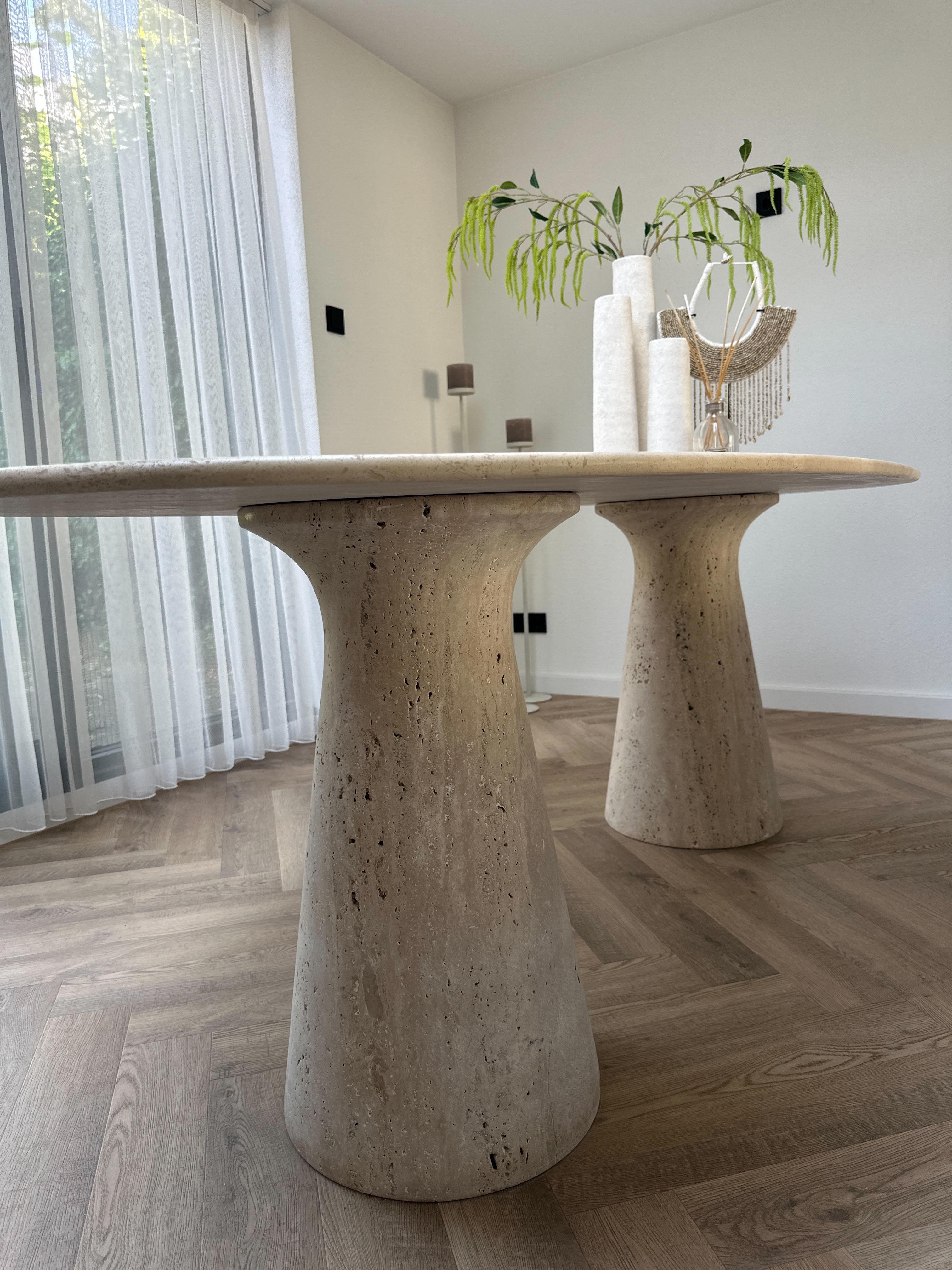 Front view of Travertine Oval Dining Table | Cone Leg with natural stone veining
