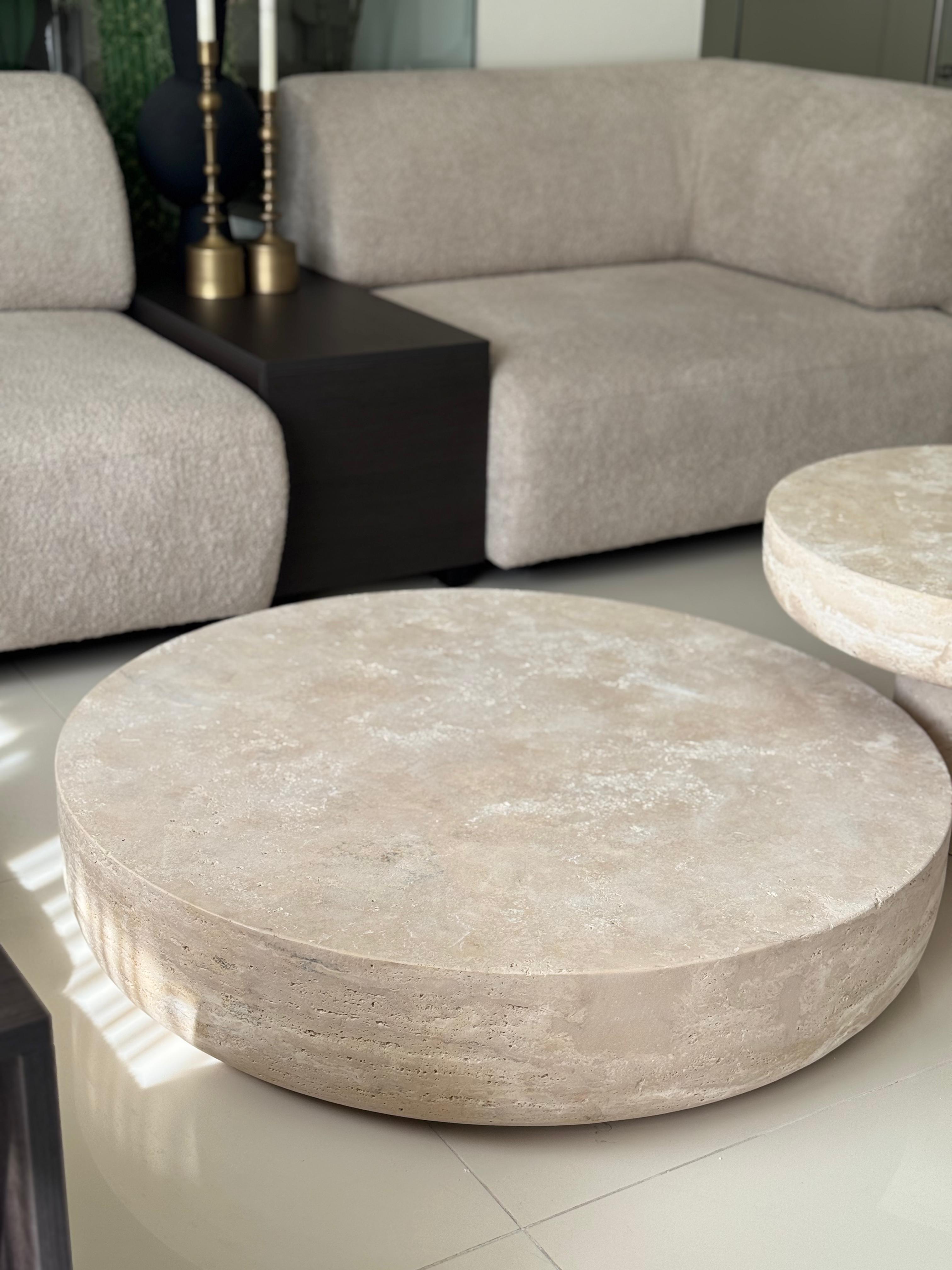 Round handmade travertine coffee table set in living room