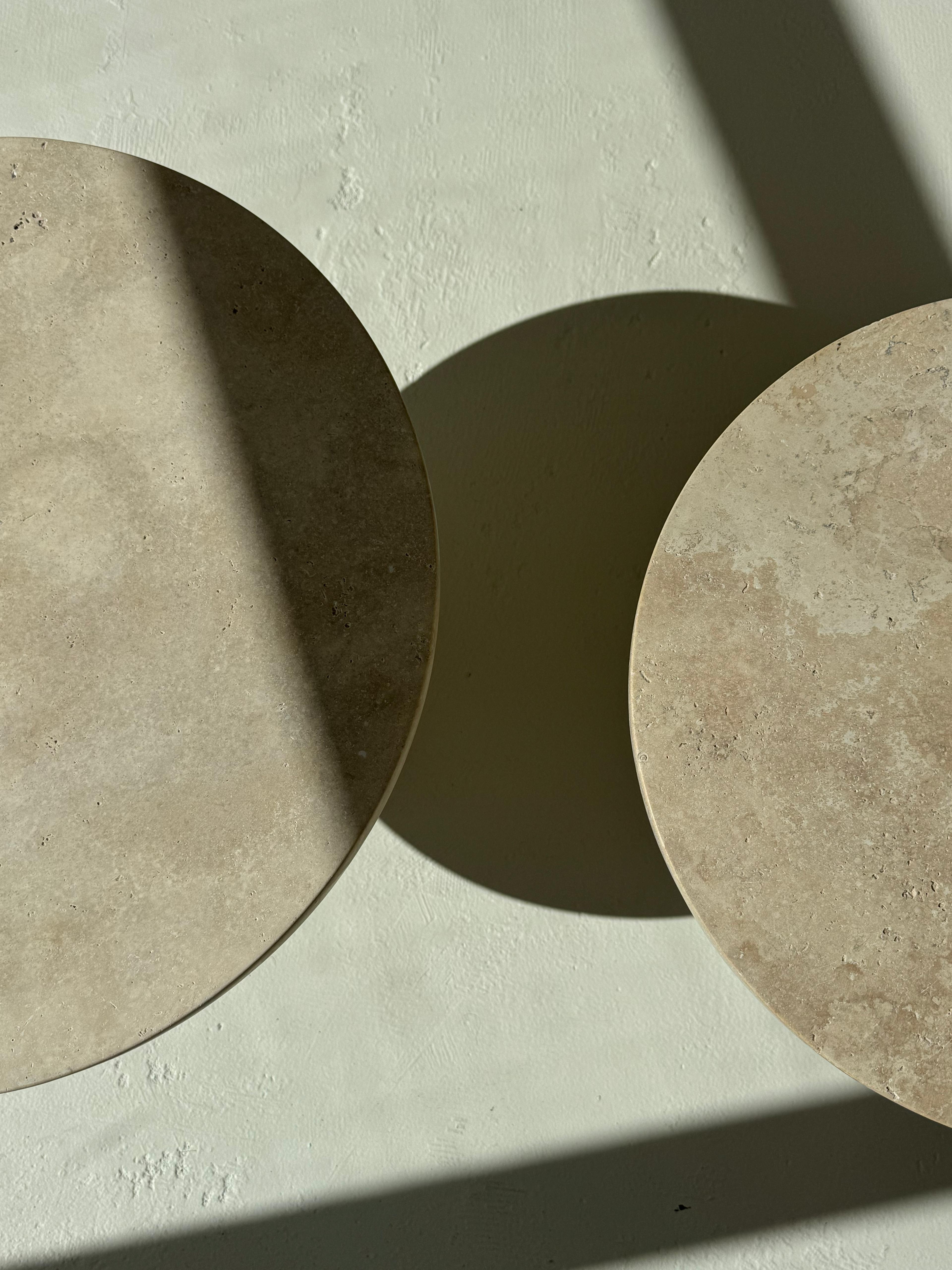 Paddy’s | Travertine Coffee Table set with smooth round tops and block-shaped bases, styled in a neutral modern interior.