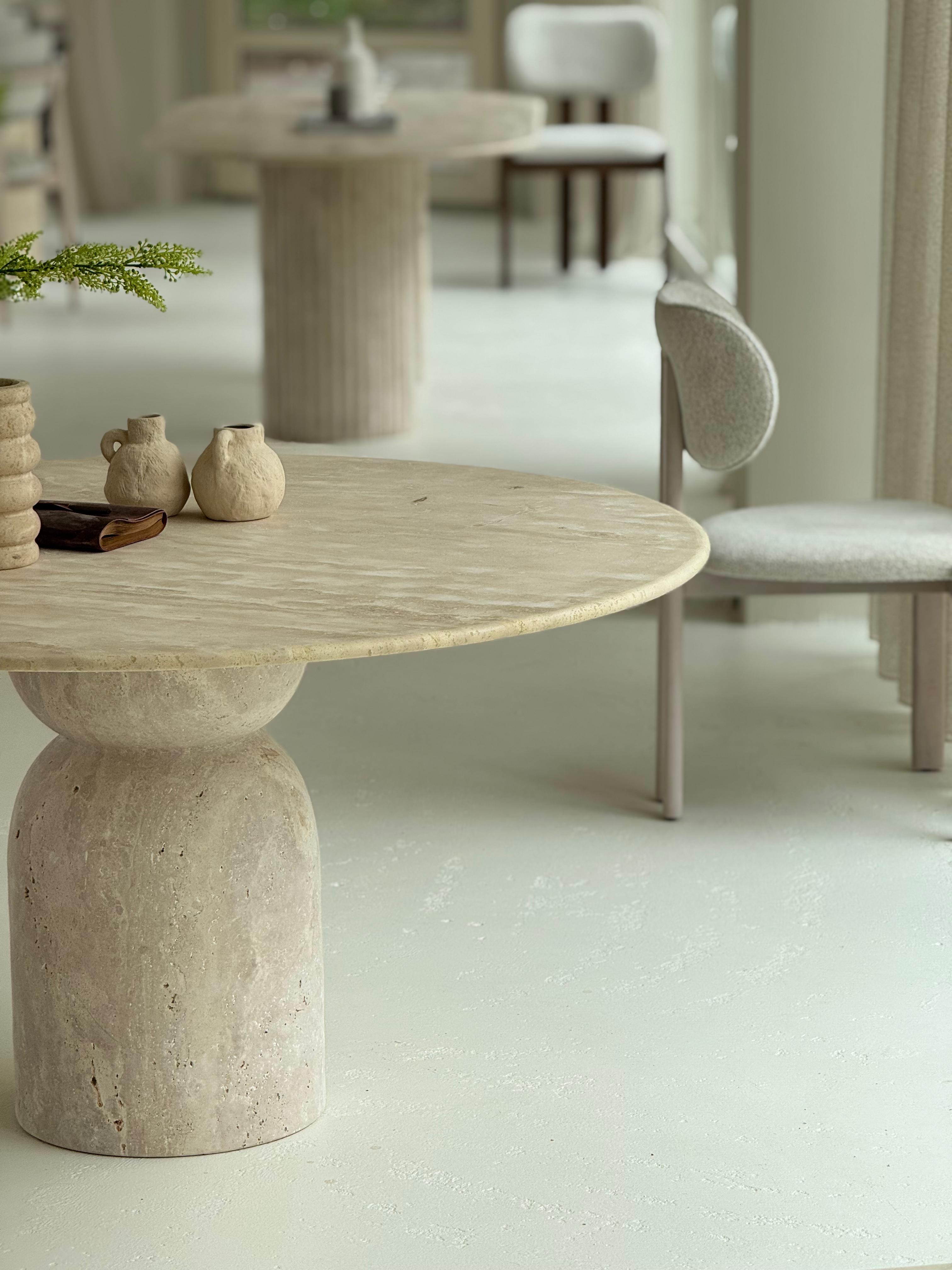 Oreo | Travertine Twist Table with sculptural twisted base and honed round top, styled in a minimalist dining interior