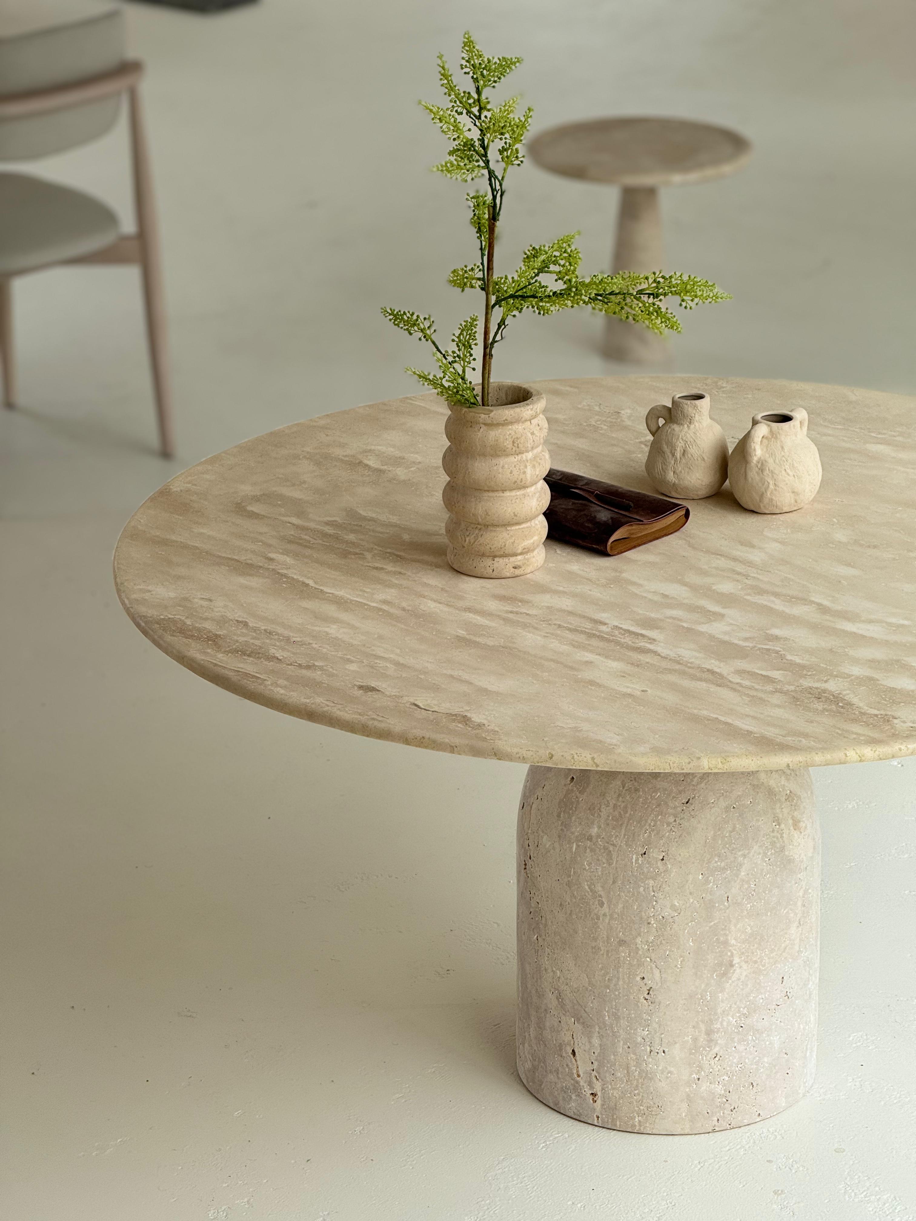 Oreo | Travertine Twist Table with sculptural twisted base and honed round top, styled in a minimalist dining interior