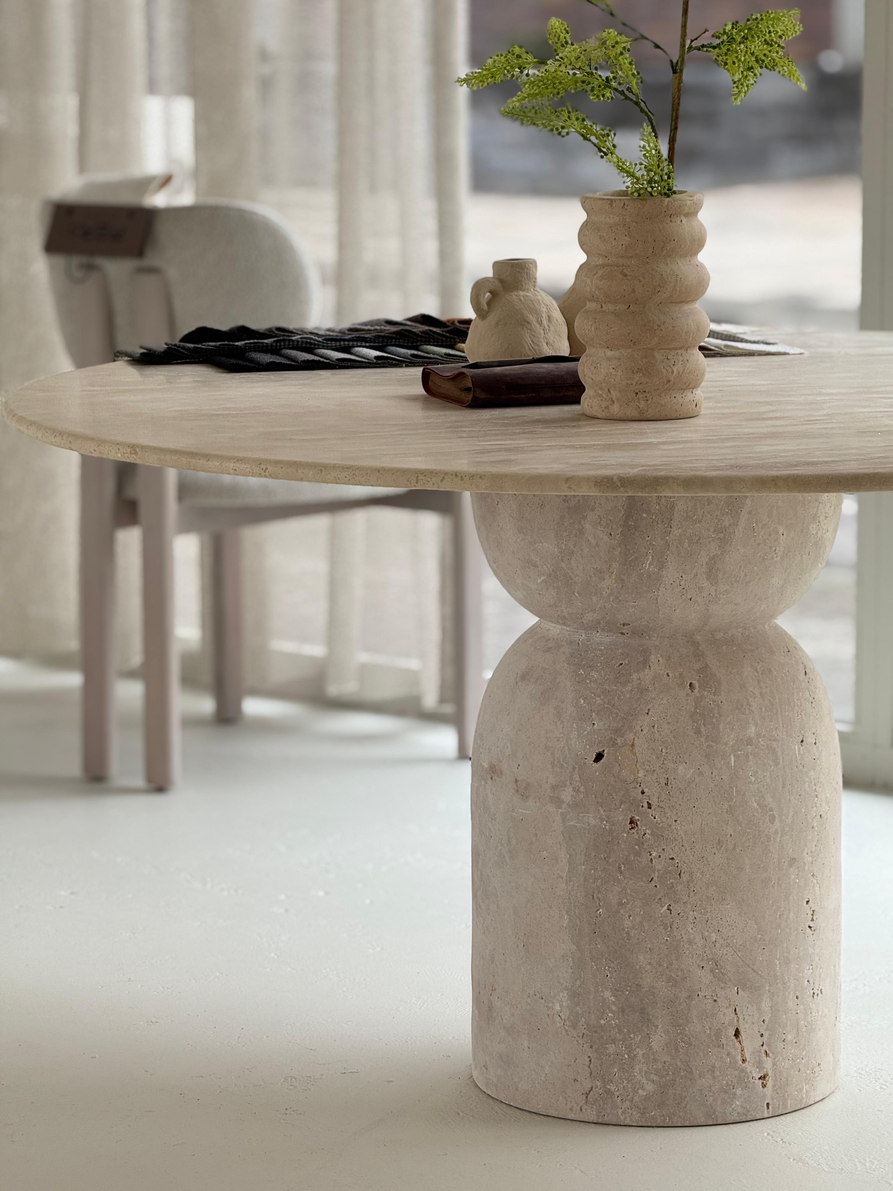 Oreo | Travertine Twist Table with sculptural twisted base and honed round top, styled in a minimalist dining interior