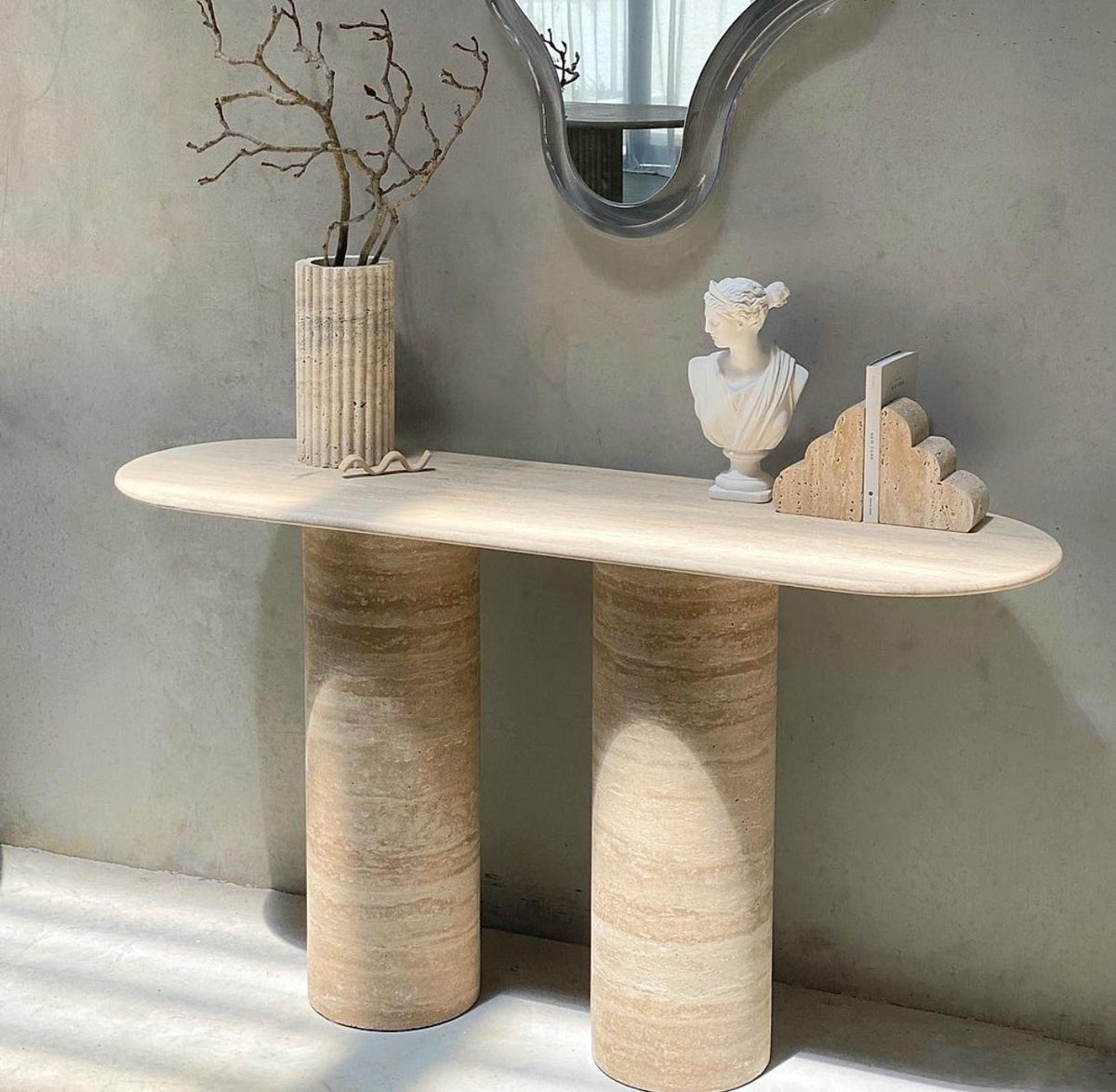 Dorica Travertine Console Table with oval top and three cylindrical legs in honed Veincut natural stone