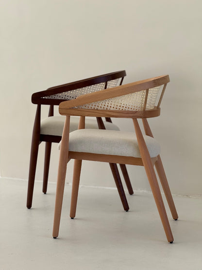 Side view of Gaia Dining Chair showing curved armrests and elegant wood grain